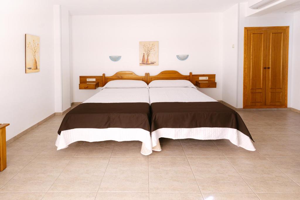 Postel nebo postele na pokoji v ubytování Hotel Rosi