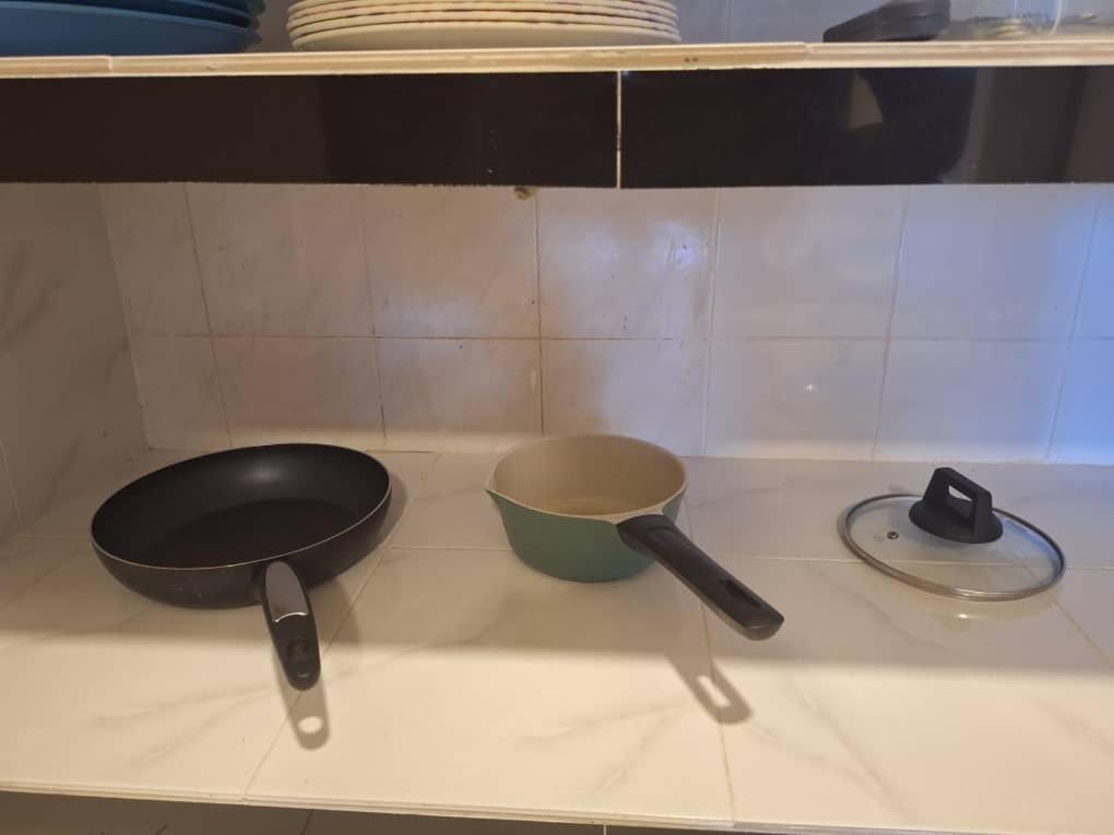 three kitchen utensils sitting on a counter top at Seaput Homes in Ayer Itam
