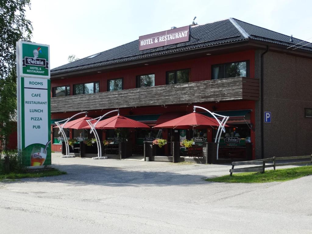 a red building with a sign in front of it at Botnia Hotel & Restaurant in Kruunupyy