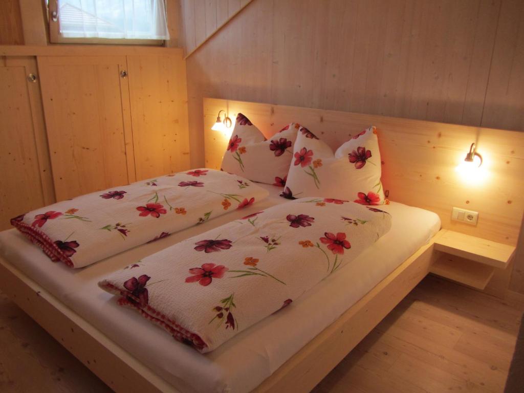 a bed with two pillows on it in a room at Liebharterhof in Valdaora