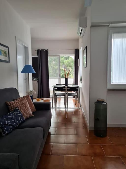 a living room with a couch and a table at Appartamento tra sole, mare e natura in Otranto