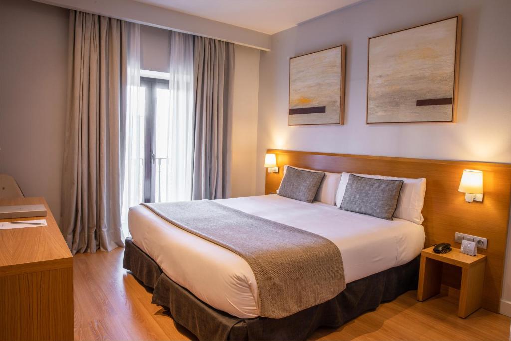 a bedroom with a large bed in a hotel room at Arc La Rambla in Barcelona