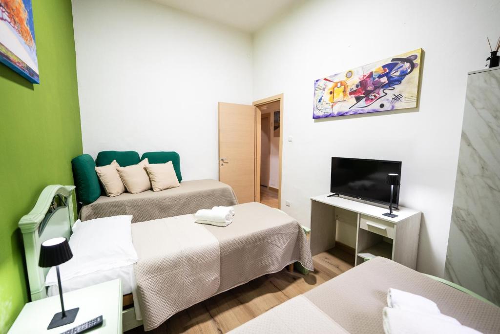 Łóżko lub łóżka w pokoju w obiekcie home Joséphine, a due passi dalla Reggia