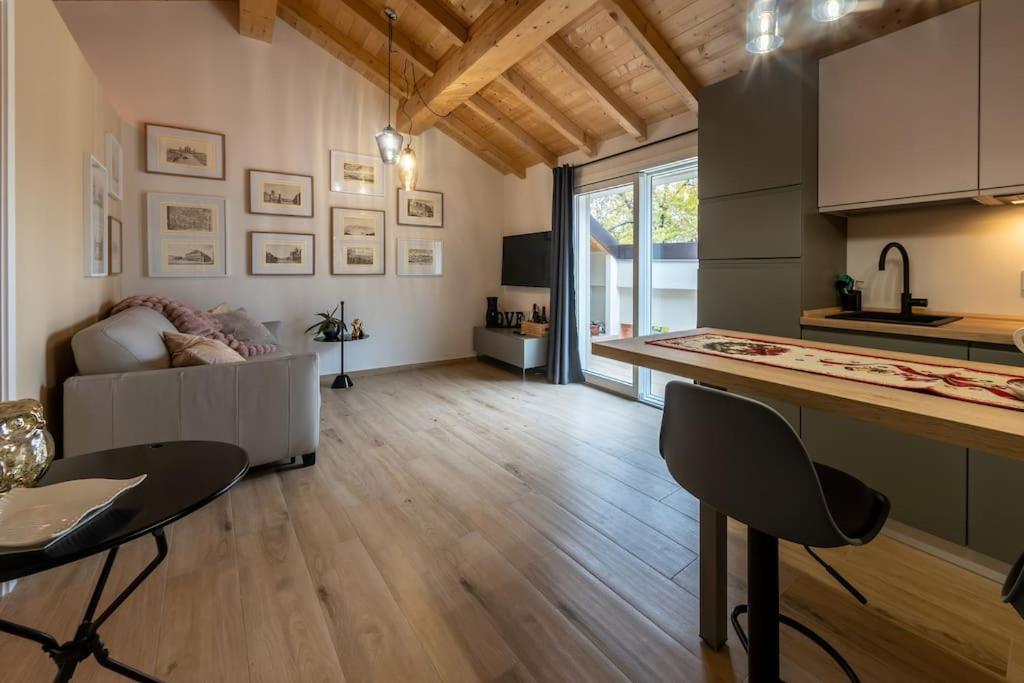 a kitchen and living room with a table and chairs at Bright Hall apartment Reggio Emilia Centro Storico in Reggio Emilia