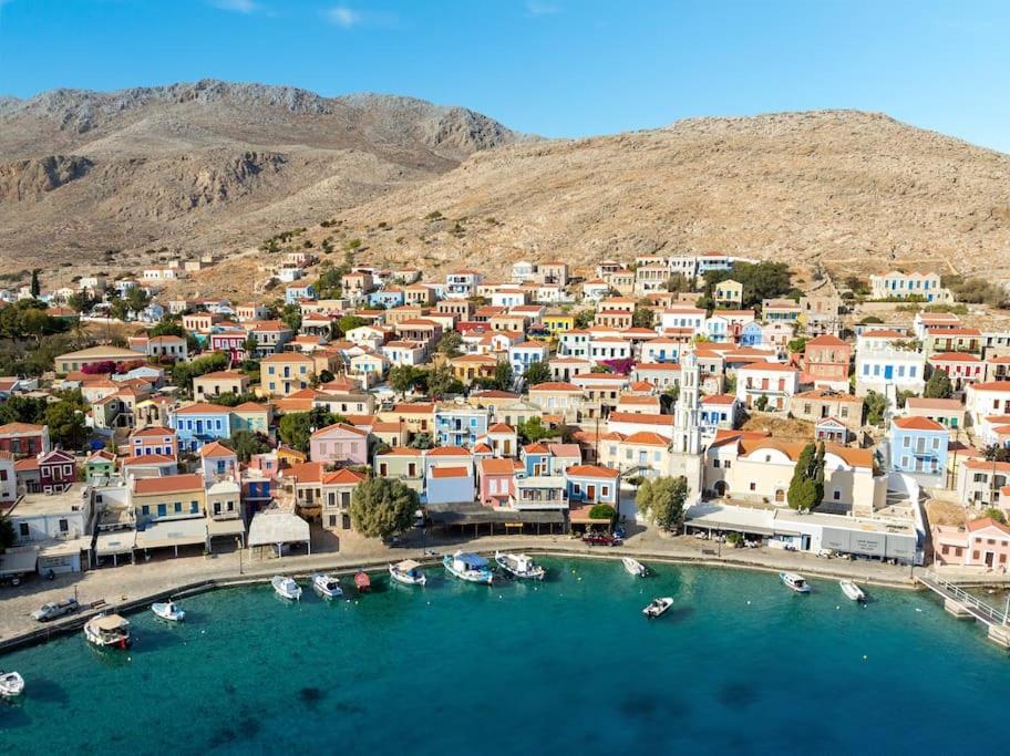 an aerial view of a town with boats in the water at Yellow Oasis traditional home with sea view in Halki