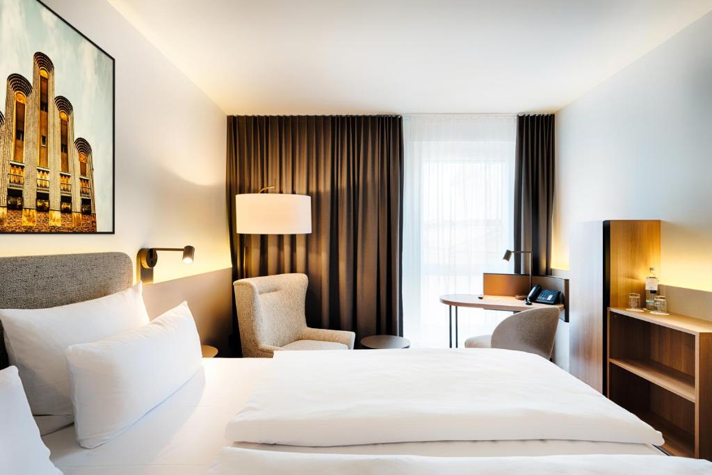 Postel nebo postele na pokoji v ubytování Welcome Hotel Darmstadt City Center