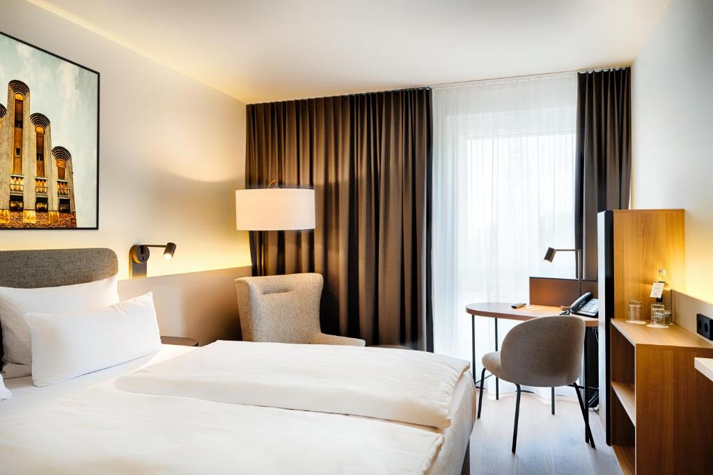 Postel nebo postele na pokoji v ubytování Welcome Hotel Darmstadt City Center