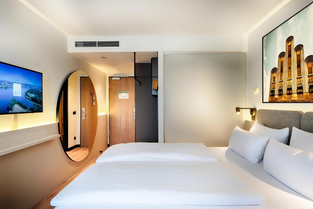 Postel nebo postele na pokoji v ubytování Welcome Hotel Darmstadt City Center