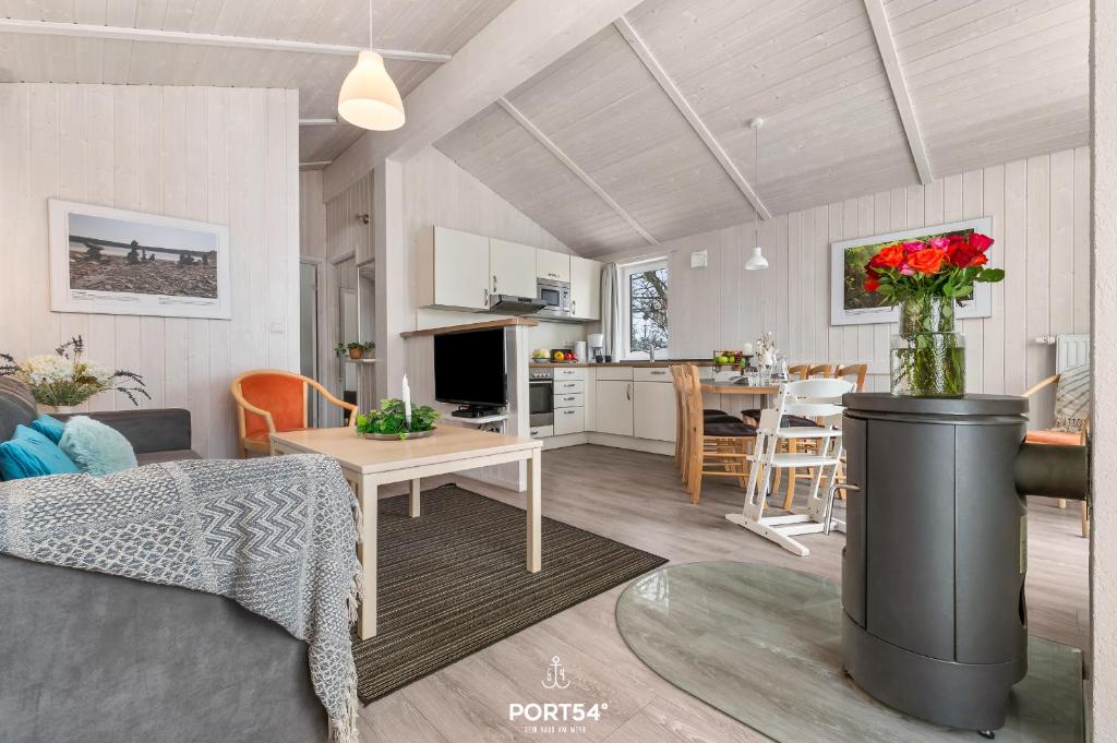 a living room and kitchen with a couch and a table at Ferienhaus Harzidylle - Sankt Andreasberg im Harz in Sankt Andreasberg