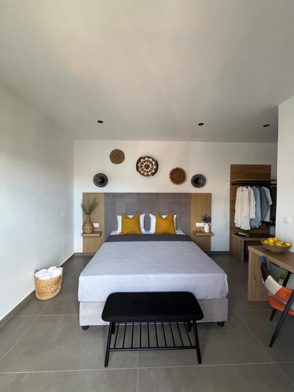 a bedroom with a large bed with yellow pillows at Cactus in Skiathos Town