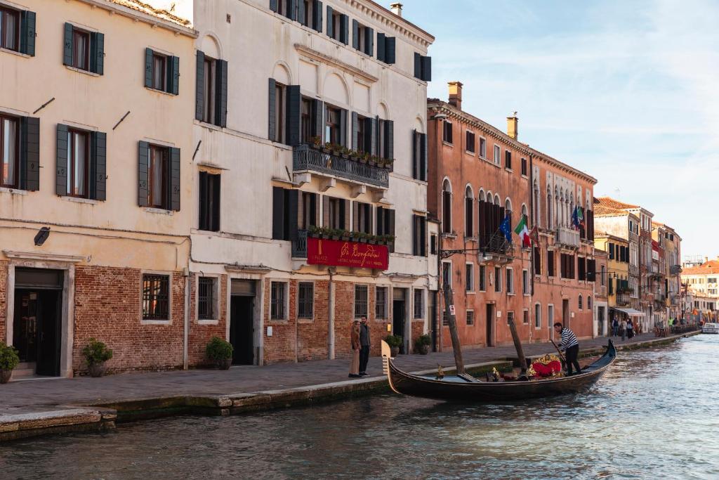 a gondola on a canal in front of buildings at Ca' Bonfadini Historic Experience in Venice