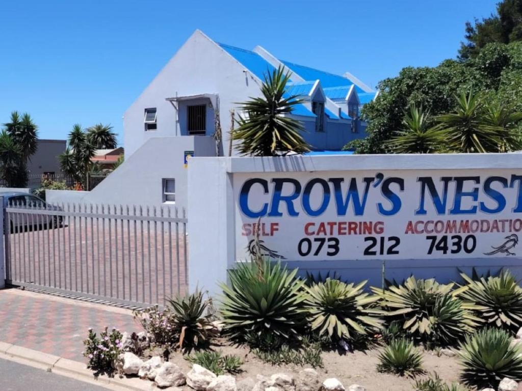a sign in front of a white house at Crow's Nest Self-Catering Accommodation in Saldanha