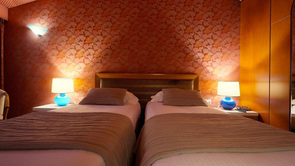 Postel nebo postele na pokoji v ubytování Hotel Motel Visconteo