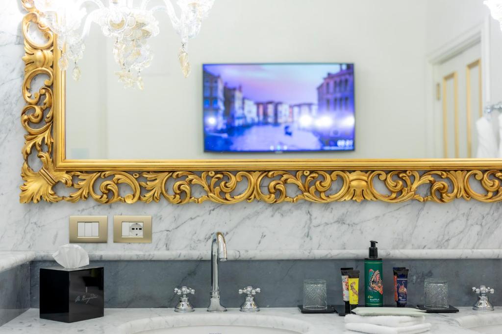 a bathroom with a sink with a mirror and a sink at Ca' Bonfadini Historic Experience in Venice