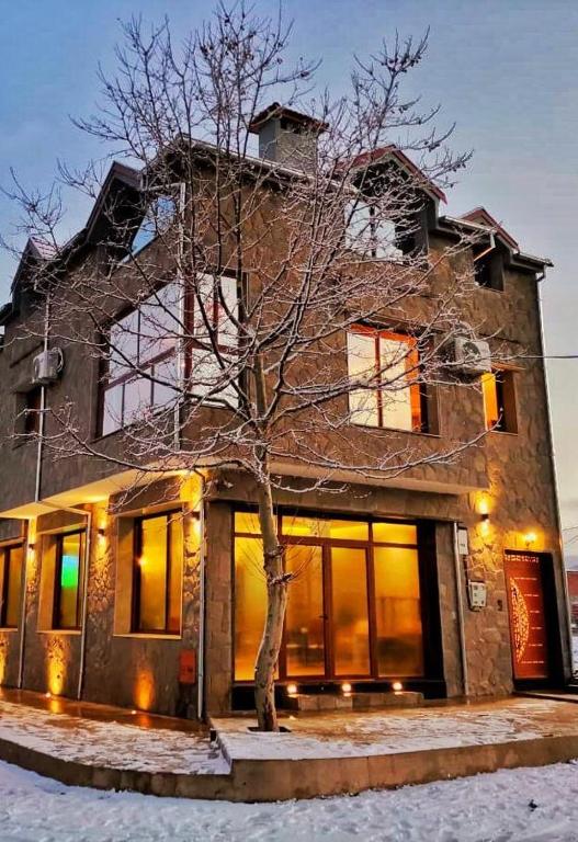 a building with a tree in front of it at شقق الاسد افران in Ifrane