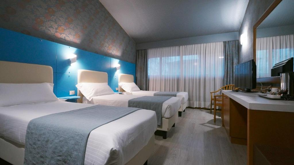 Postel nebo postele na pokoji v ubytování Hotel Motel Visconteo