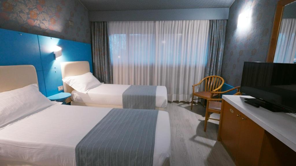 Postel nebo postele na pokoji v ubytování Hotel Motel Visconteo