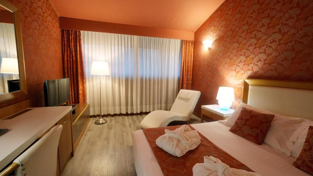 Postel nebo postele na pokoji v ubytování Hotel Motel Visconteo