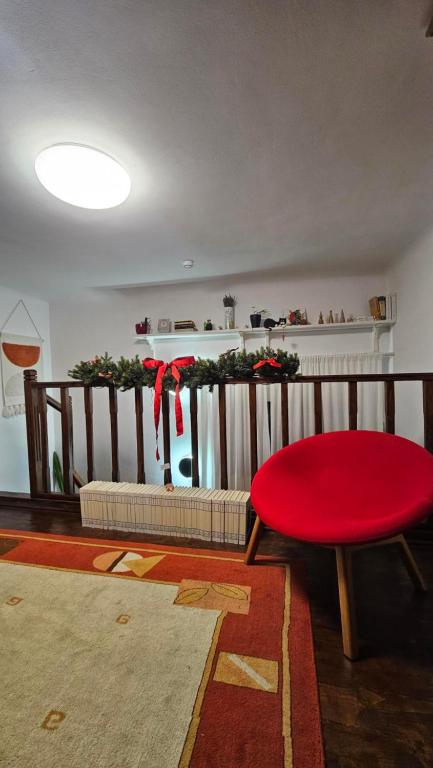 a living room with a red stool and a table at Napoca Ultracentral Loft in Cluj-Napoca