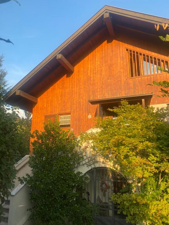 an orange building with trees in front of it at Chalet Genziana in Cavalese