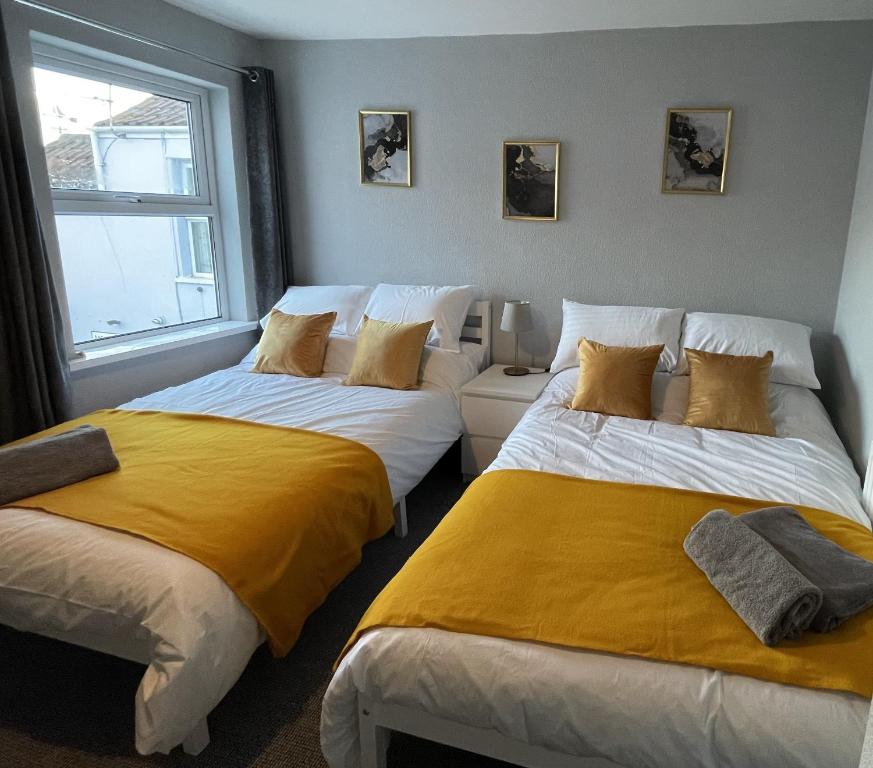 two beds sitting next to each other in a room at Admiral Blake Guesthouse in Bridgwater