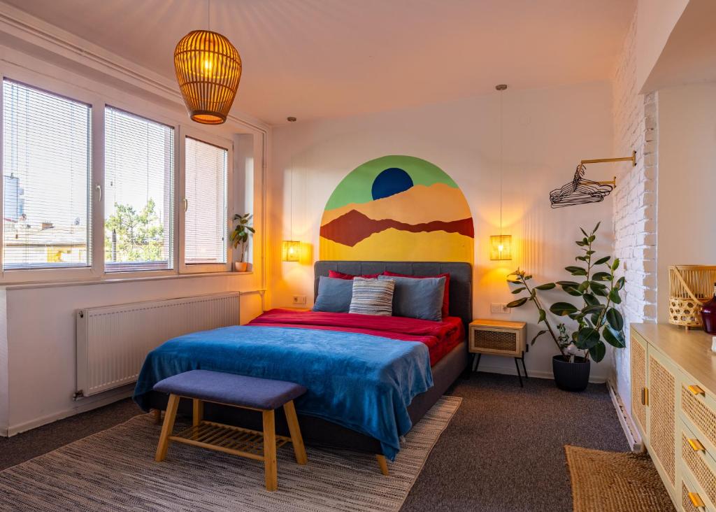 a bedroom with a bed with a painting on the wall at Sunny & Bright Central in Pristina