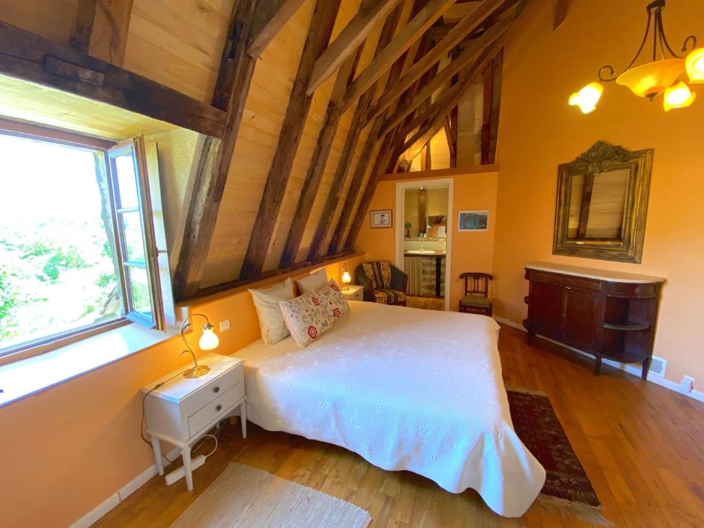 a bedroom with a white bed and a window at Le Chateau de Busqueilles La Suite in Autoire