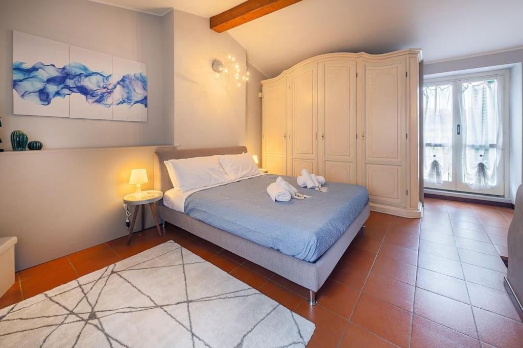 a bedroom with a bed and a cabinet at Oasi in centro Bergamo - terrazza privata in Bergamo