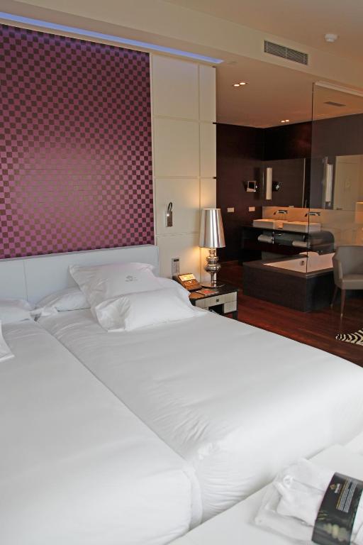 A bed or beds in a room at Gran Hotel Nagari Boutique & Spa