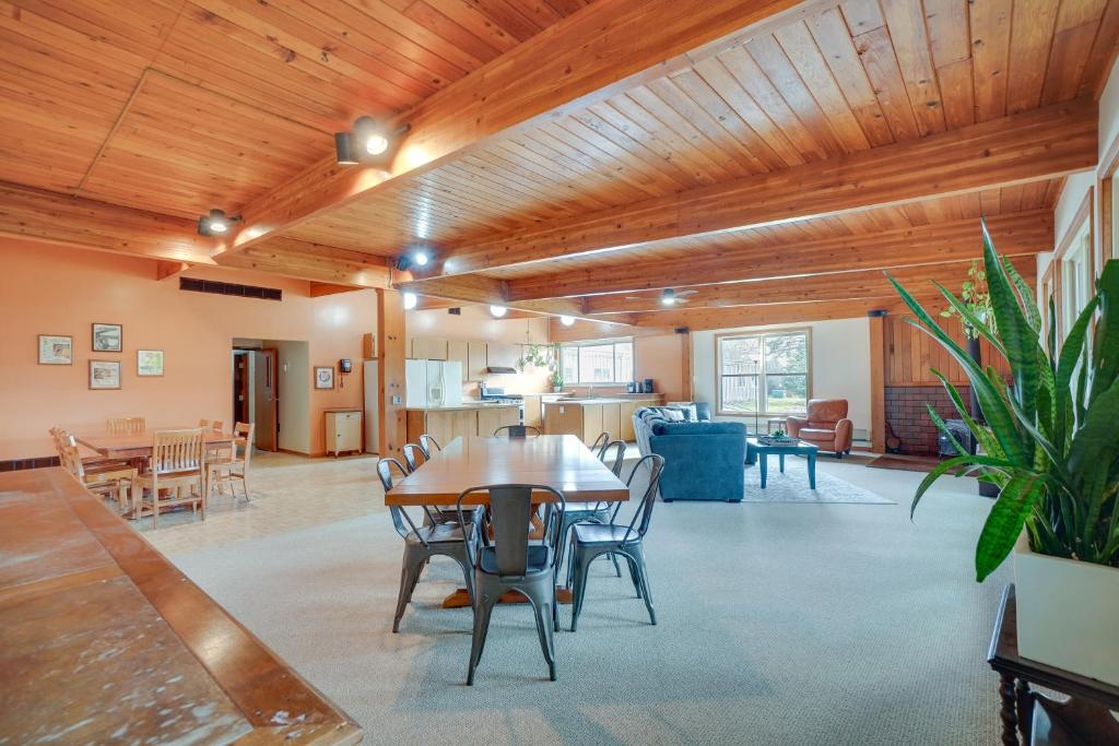 a living room with wooden ceilings and a table and chairs at Grand Rural Wisconsin Retreat Full Indoor Gym in Mount Calvary