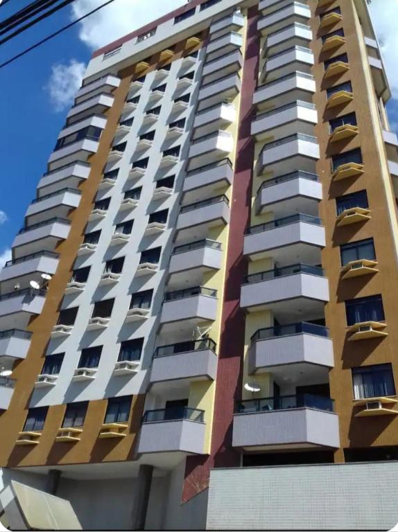 a tall building with balconies on the side of it at flat no centro da Cidade in Campos dos Goytacazes