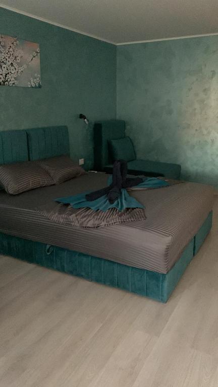 a large bed in a bedroom with green walls at Neversea Boutique Villa in Constanţa