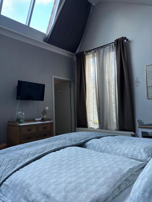 Postel nebo postele na pokoji v ubytování Guesthouse de Loft