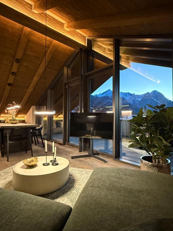 a living room with a couch and a piano at LIVALPIN Hideaway in Garmisch-Partenkirchen