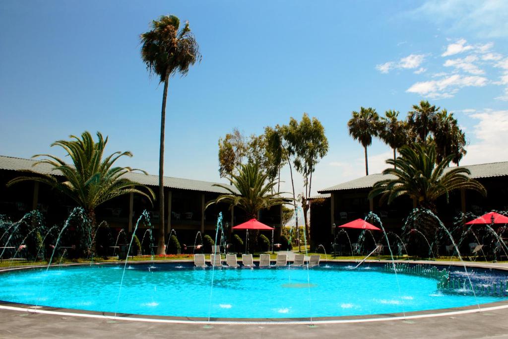 a large swimming pool with water fountain at Costa del Sol Wyndham Trujillo in Trujillo