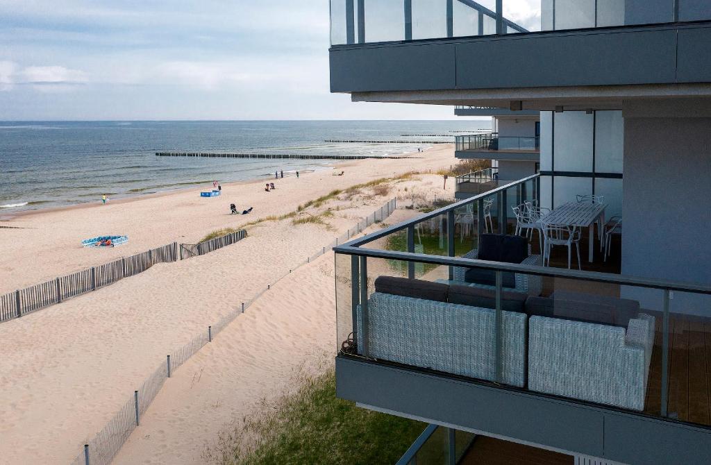 a view of the beach from a balcony of a condo at Apartament Dream View Gardenia Front in Dziwnów