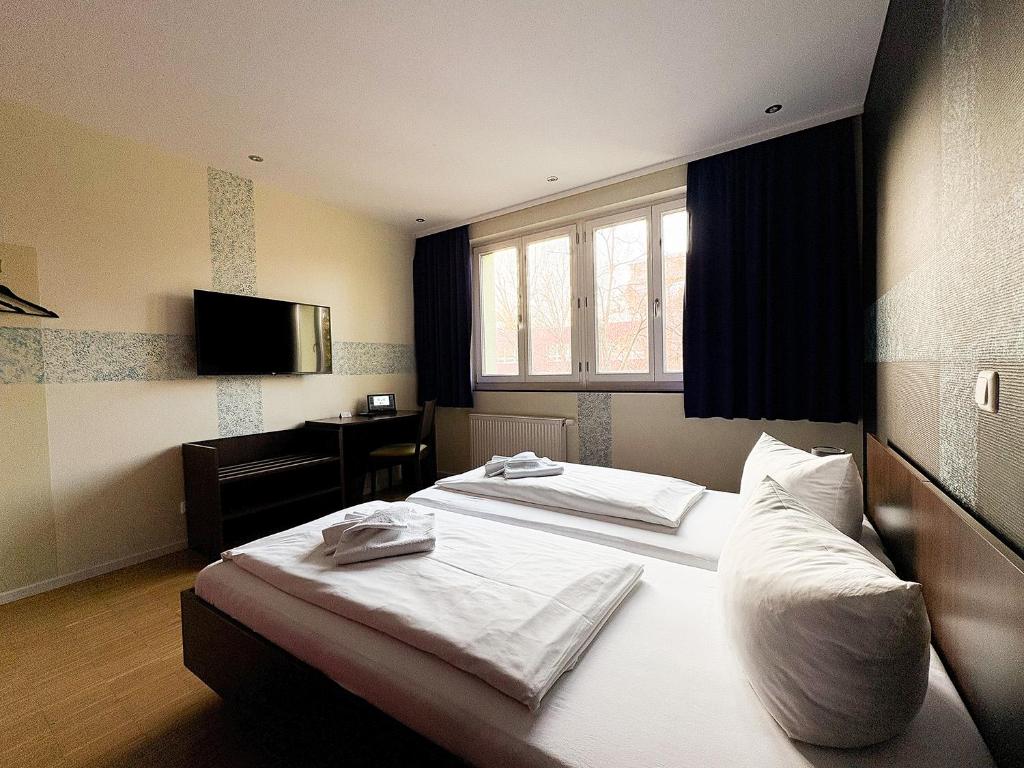 Postel nebo postele na pokoji v ubytování HOLI City Apart Hotel Berlin