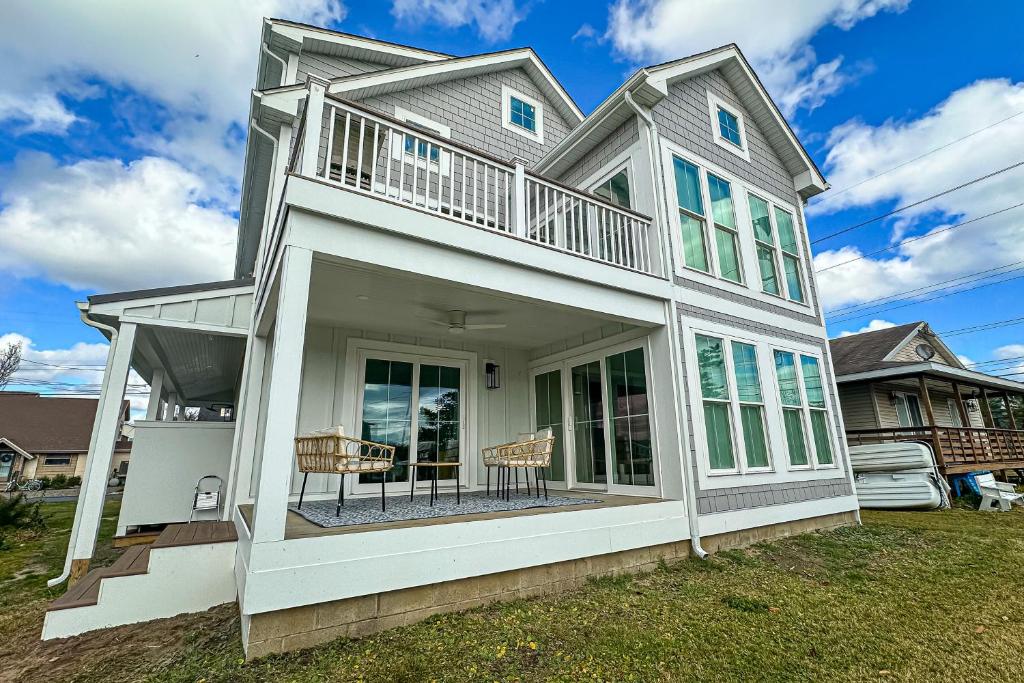 a white house with two chairs on a lawn at South Bethany --- 102 Brandywine Dr in Bethany Beach