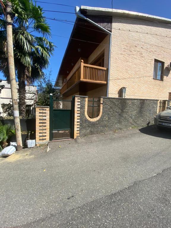 a house with a balcony on the side of it at Gogol House in Kutaisi