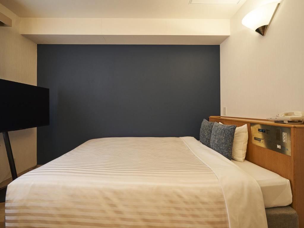 Postel nebo postele na pokoji v ubytování Hotel Toms