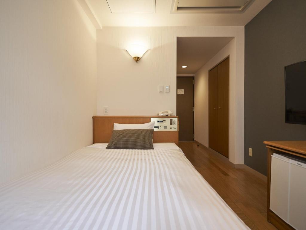 Postel nebo postele na pokoji v ubytování Hotel Toms