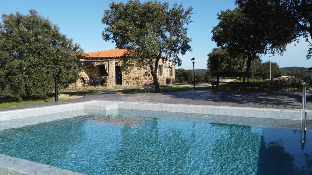a swimming pool in front of a house at Casas Rurales Racha Rachel, Zarza la Mayor in Zarza la Mayor