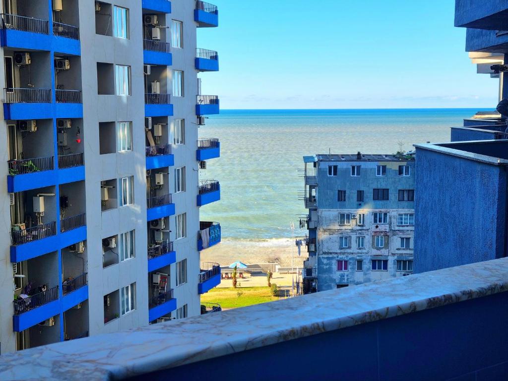 a view of the ocean from the balcony of a building at Sea apartment baTumi in Batumi