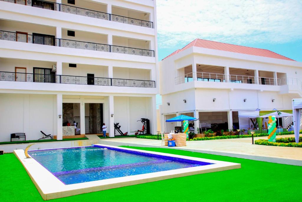 a swimming pool in front of a building at America Guest House in Lomé