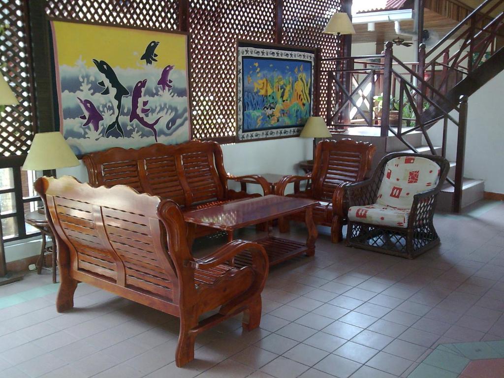 a living room with chairs and a stair case at Pangkor Bay View Beach Resort in Pangkor