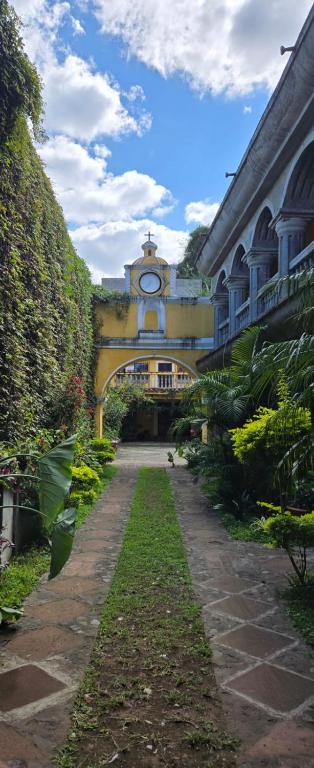 a building with a clock on the side of it at Ciudad Vieja Bed & Breakfast Hotel Casa del Turista in San Lorenzo El Cubo