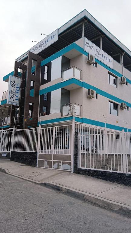 a building with a white fence in front of it at Hotel Stella blu in Manta