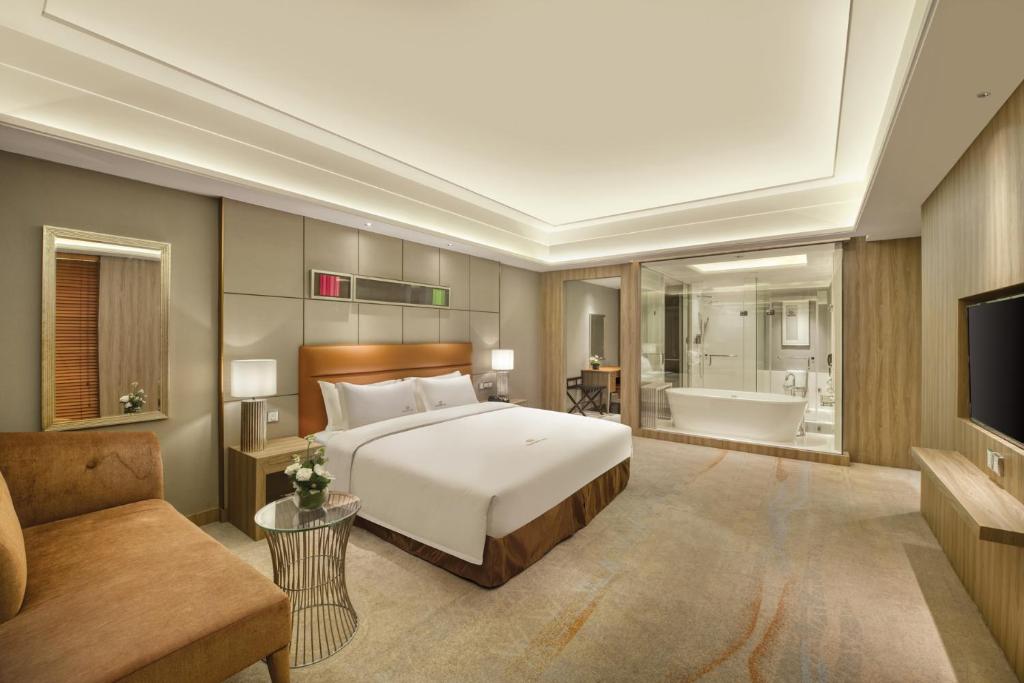 Postel nebo postele na pokoji v ubytování Dongguan Royal Garden Hotel