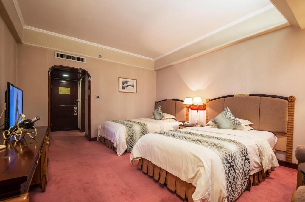 Postel nebo postele na pokoji v ubytování Panyu Hotel