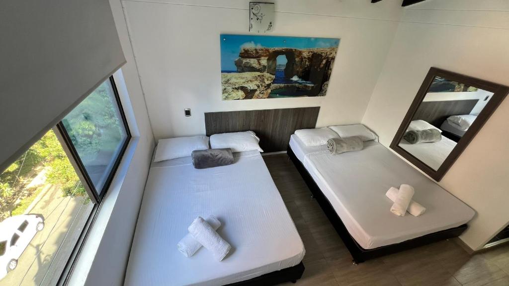 Postel nebo postele na pokoji v ubytování Hotel Jardin de Laureles Jeps